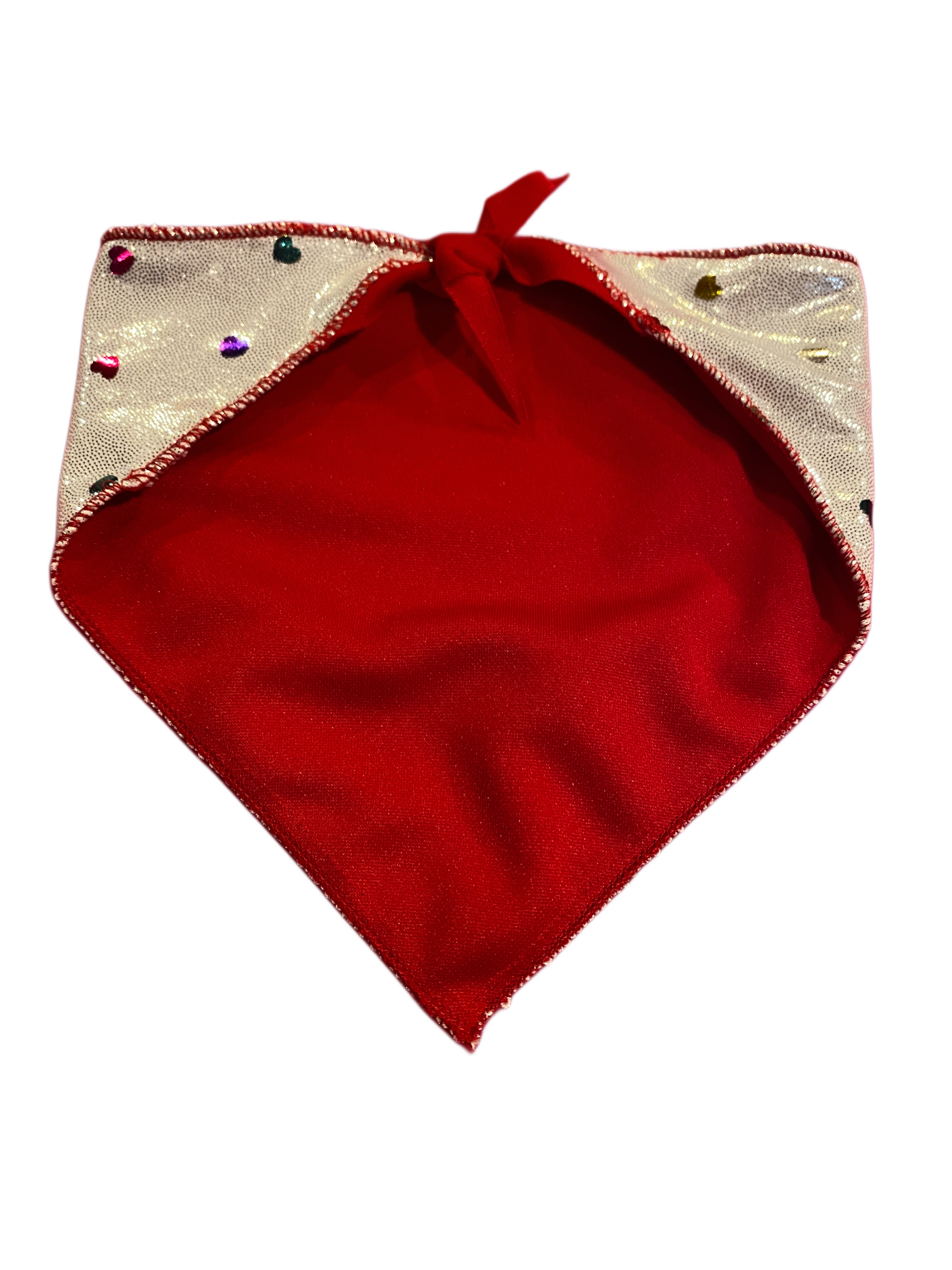 Red back side of a metallic silver dog bandana with rainbow hearts.