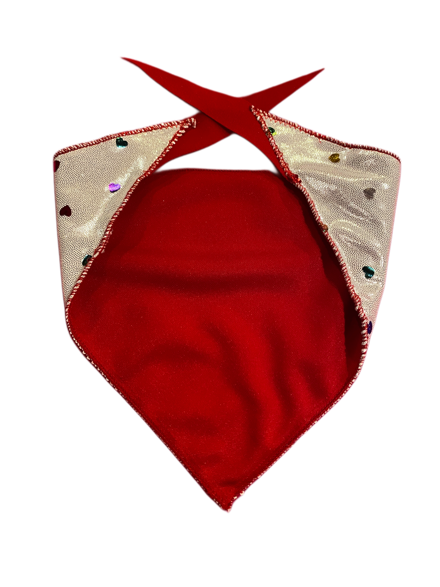 Red back side of a metallic silver dog bandana with rainbow hearts.