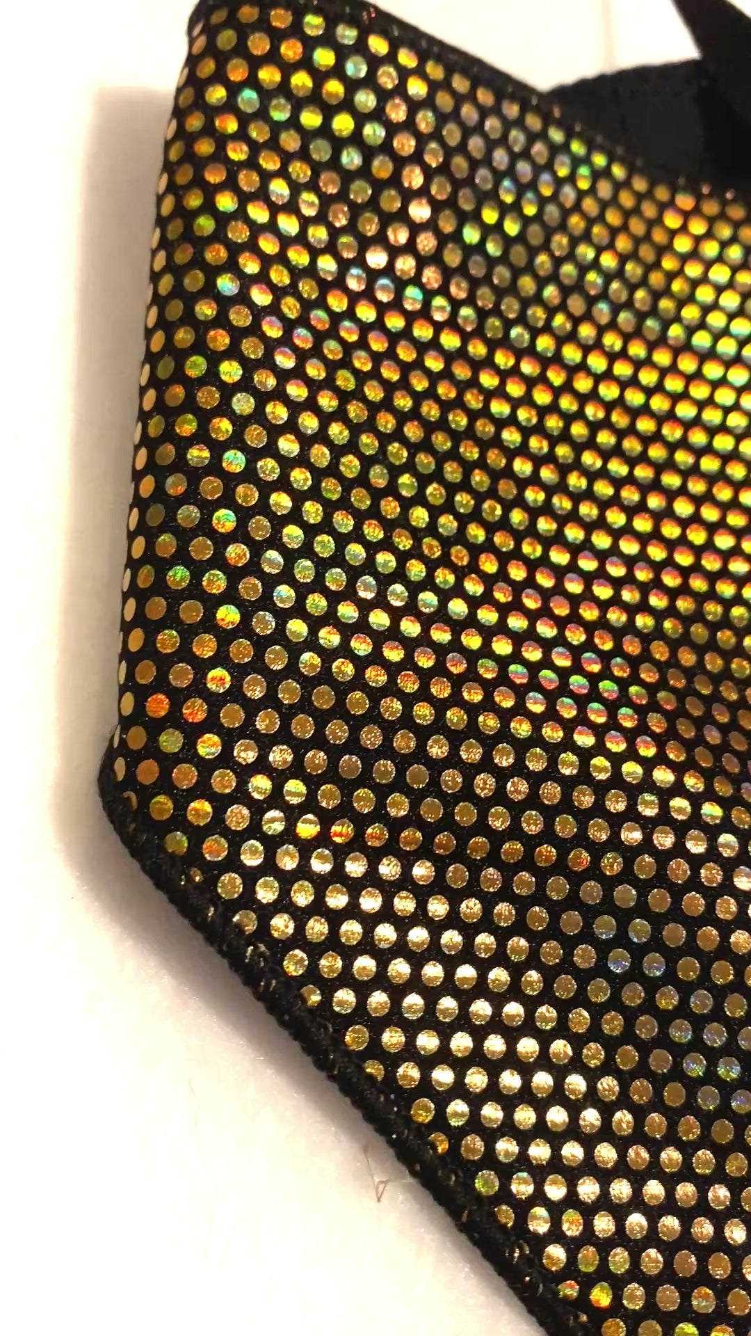Gold dot iridescent dog bandana with black lining.